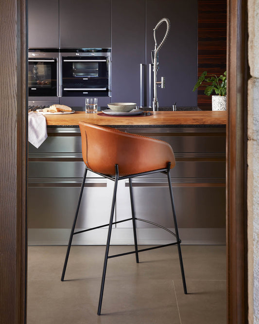 Brown synthetic leather Yvette barstool with steel legs in a black finish height 75 cm