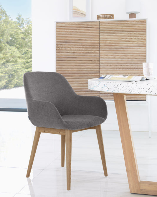 Konna chair in dark grey with solid ash wood legs in a dark finish