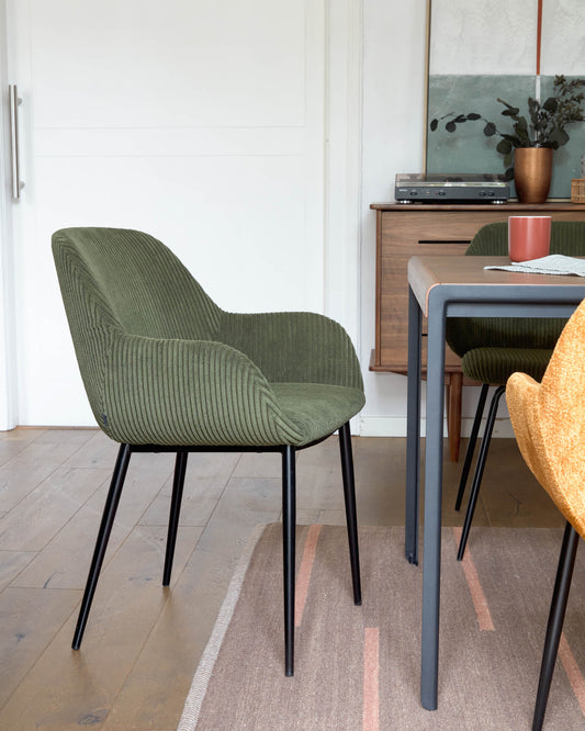 Konna chair in dark green wide seam corduroy with steel legs and black painted finish