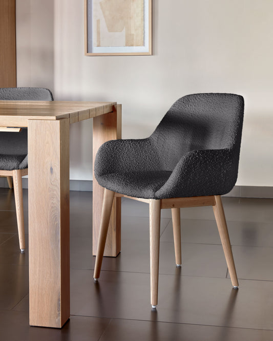 Konna chair in black bouclé with solid ash wood legs in a natural finish