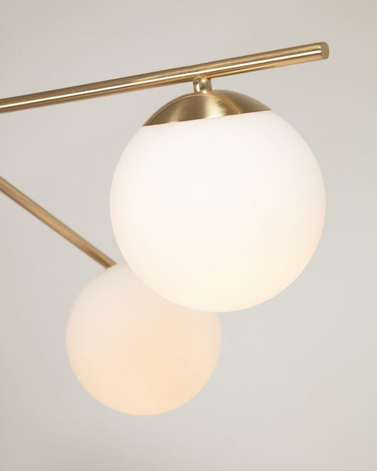 Mahala steel ceiling light with brass finish and three frosted glass spheres