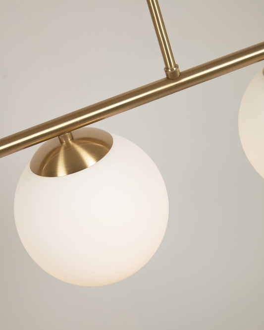 Mahala ceiling light with steel detail and brass finish and three frosted glass spheres